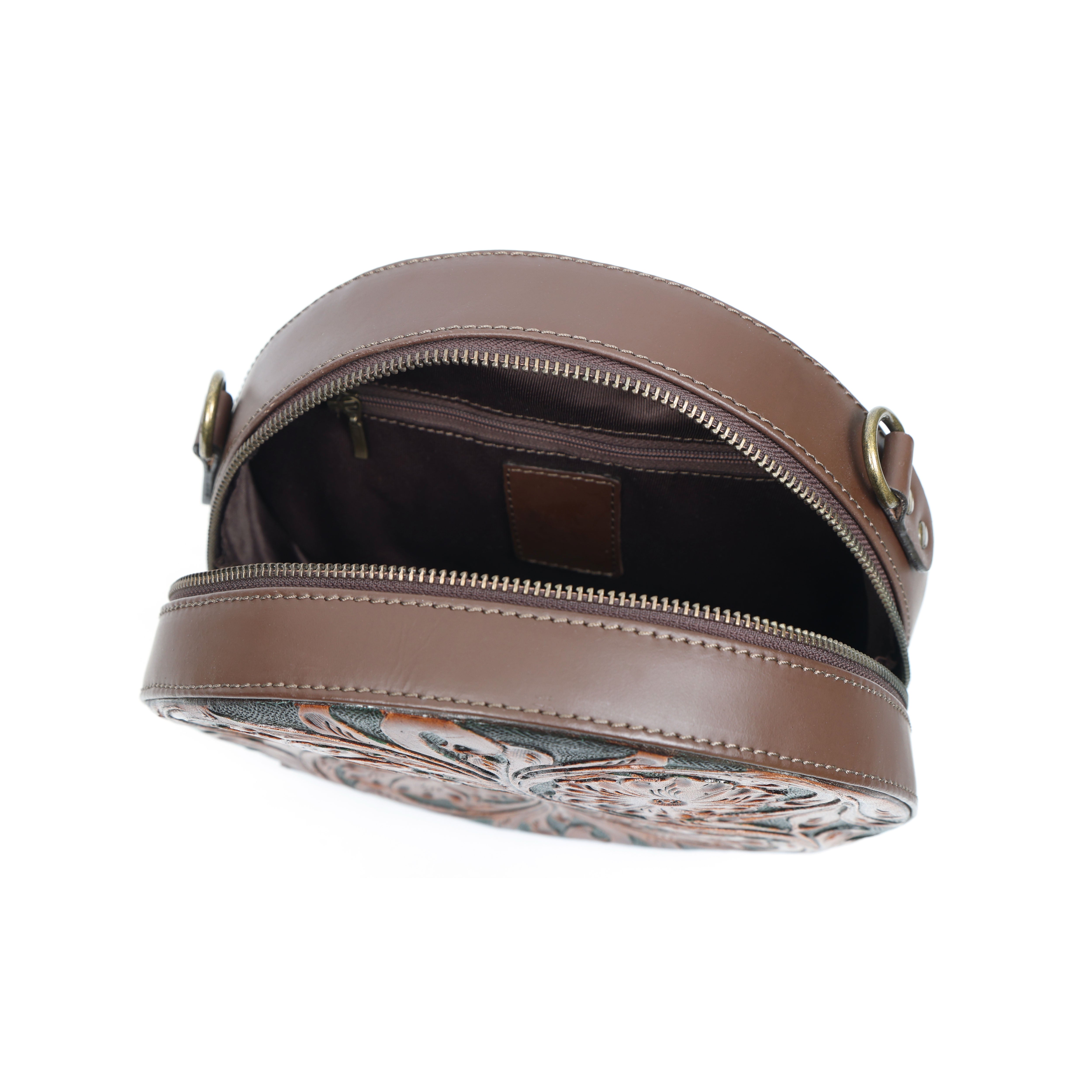 Brown leather bag with floral pattern on a white background