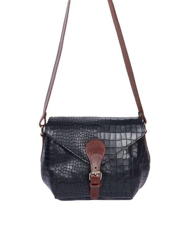 A black crocodile patterned leather sling bag with brown leather accents and a buckled flap closure.