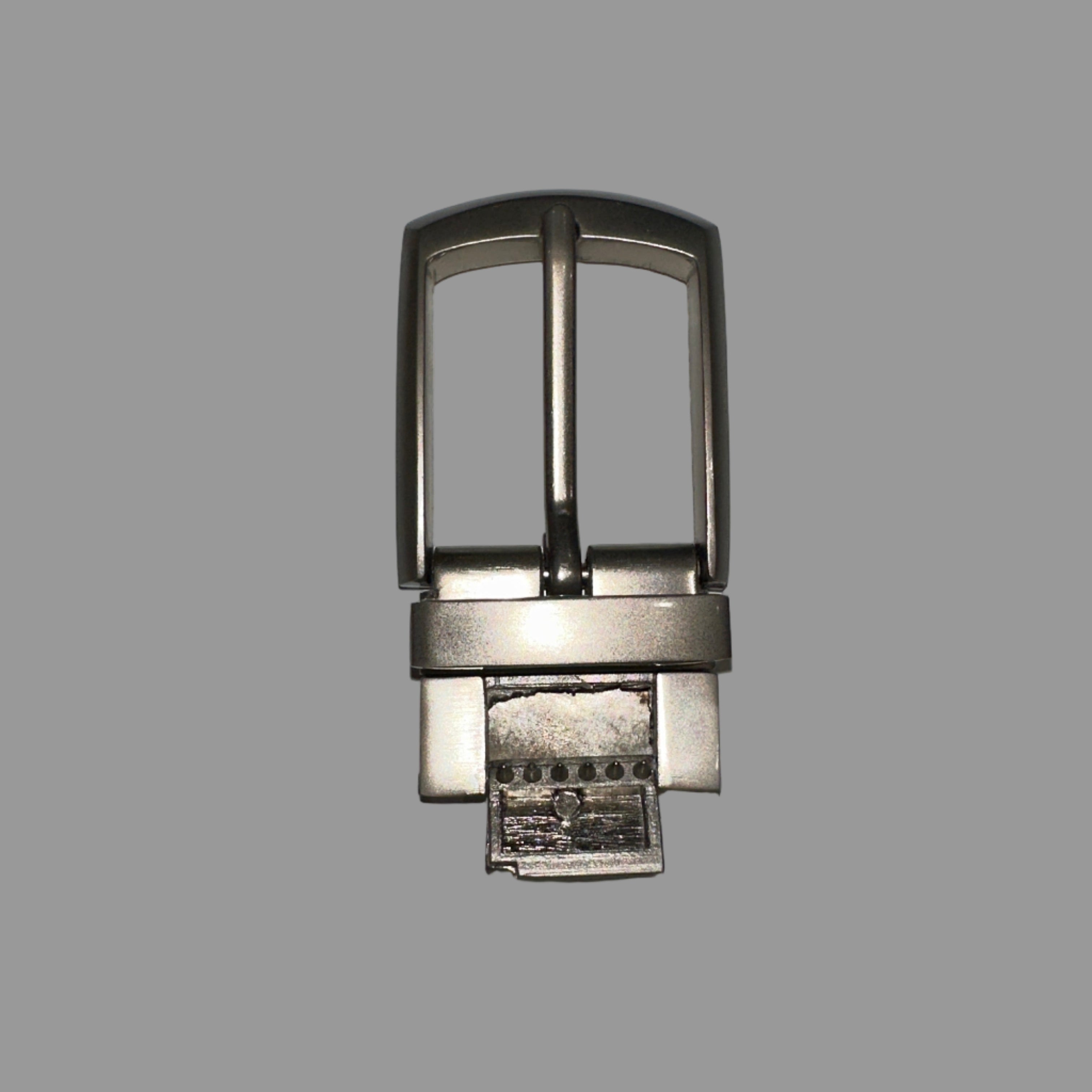 Metallic belt buckle on a light gray background