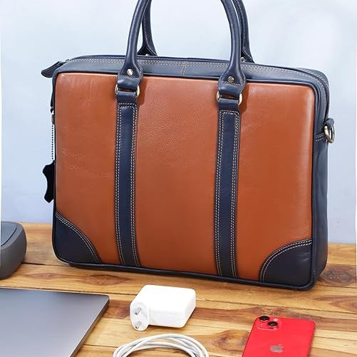 Brown and black leather briefcase on a wooden surface with electronic devices.