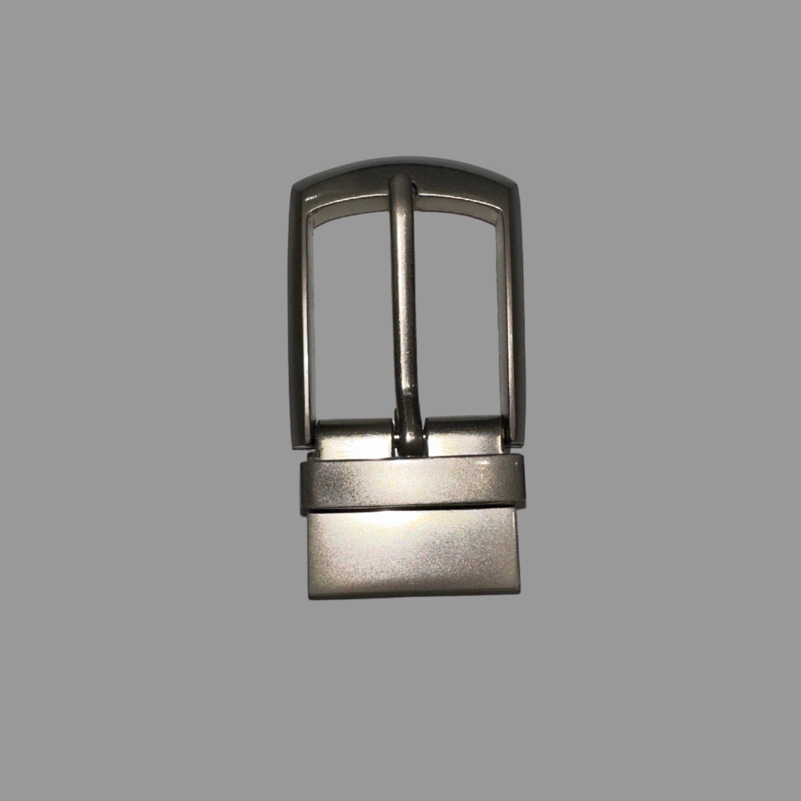 Metallic belt buckle on a light gray background