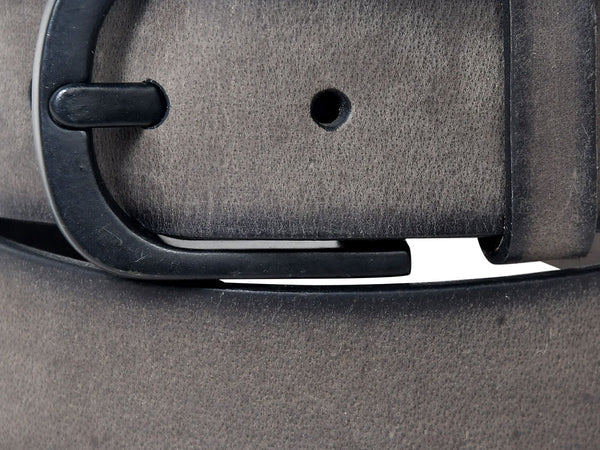 Close-up of a grey leather belt with a black buckle, focusing on the leather texture.