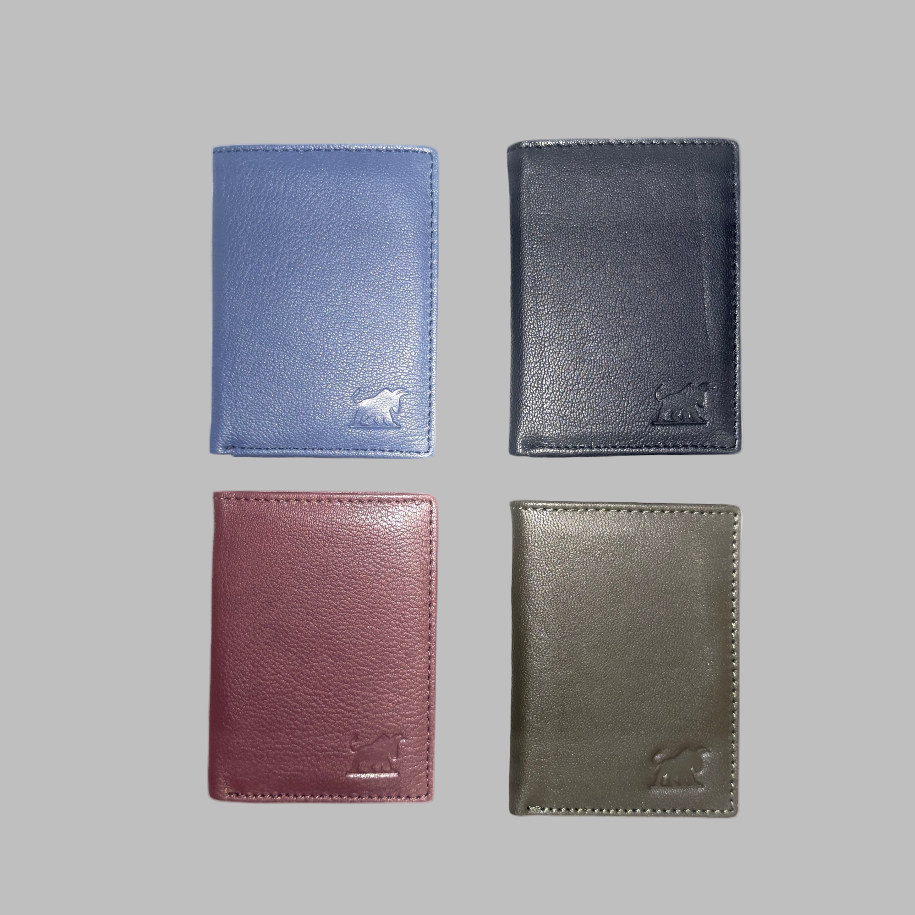 Four leather wallets in blue, black, red, and green on a white background