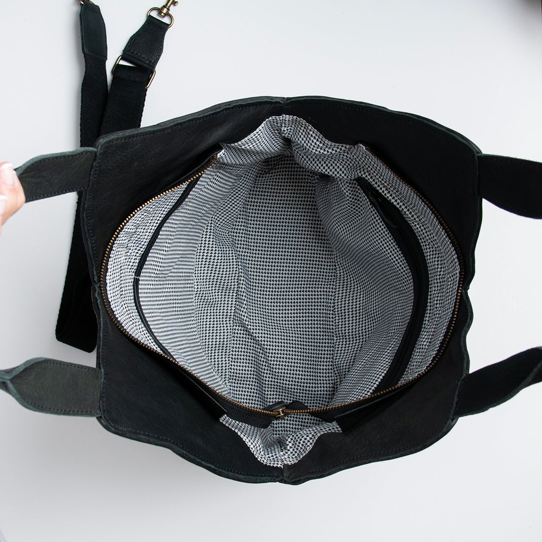 Black backpack with a mesh pocket on a white background