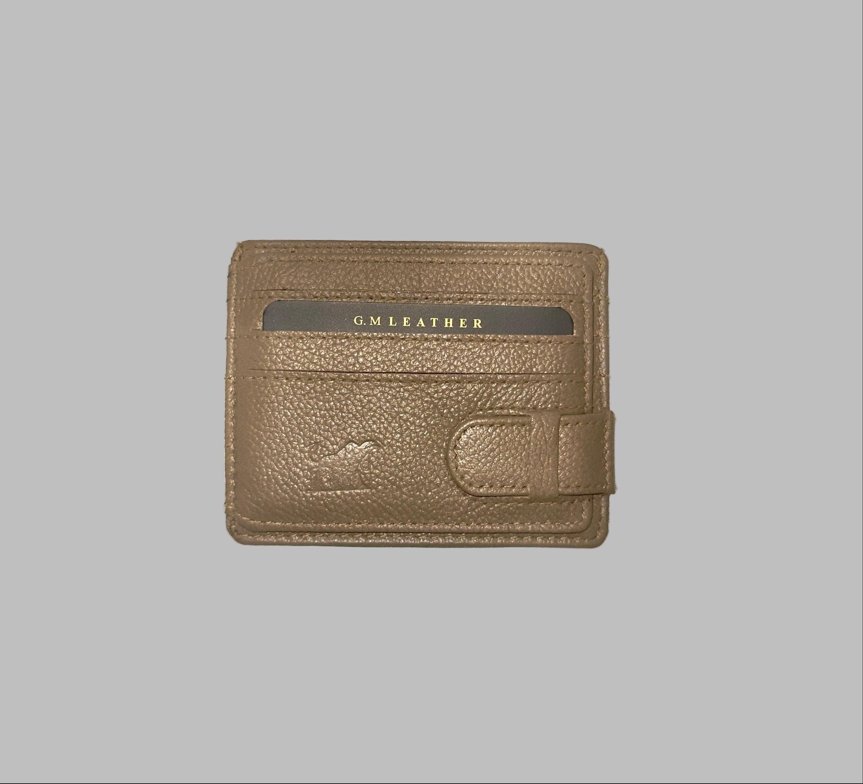 Brown leather wallet with 'G.M. Leather' branding on a white background