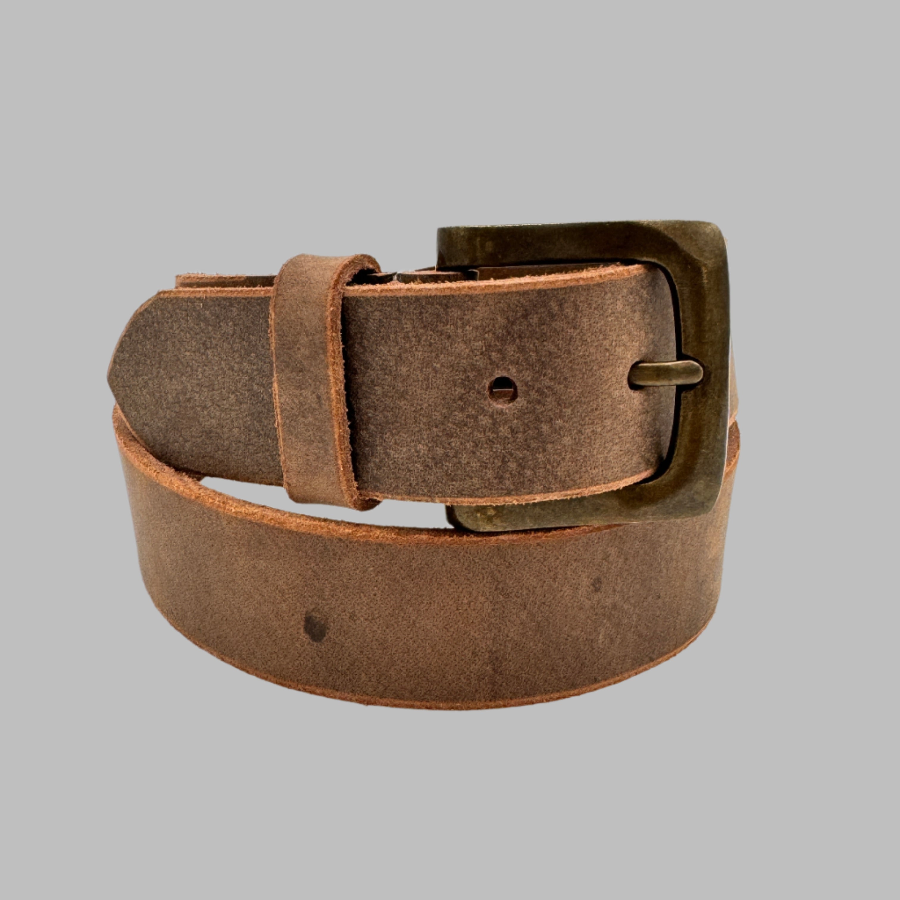A brown full-grain leather belt with a natural tan color, featuring a buckle and a texture that suggests durability and natural leather finish.