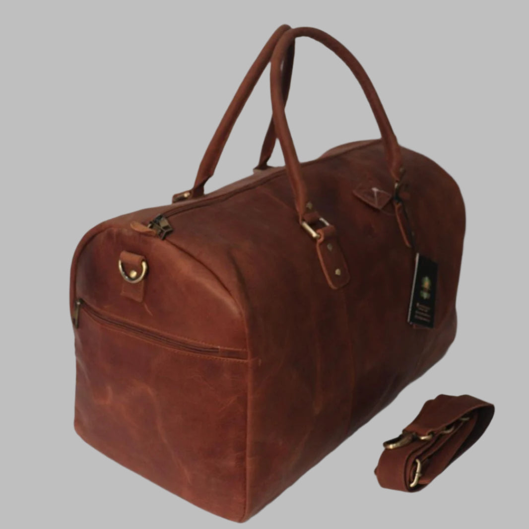 A brown leather duffle bag with a detachable shoulder strap and sturdy handles.