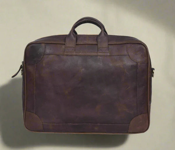 A brown leather laptop bag with a zipper closure and handles.