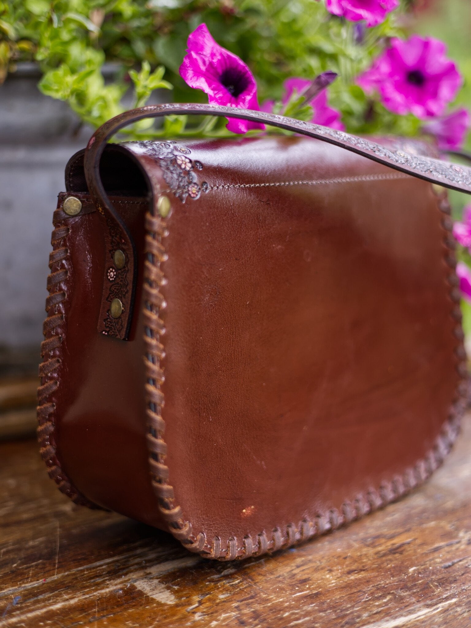 Brown leather bag with floral background