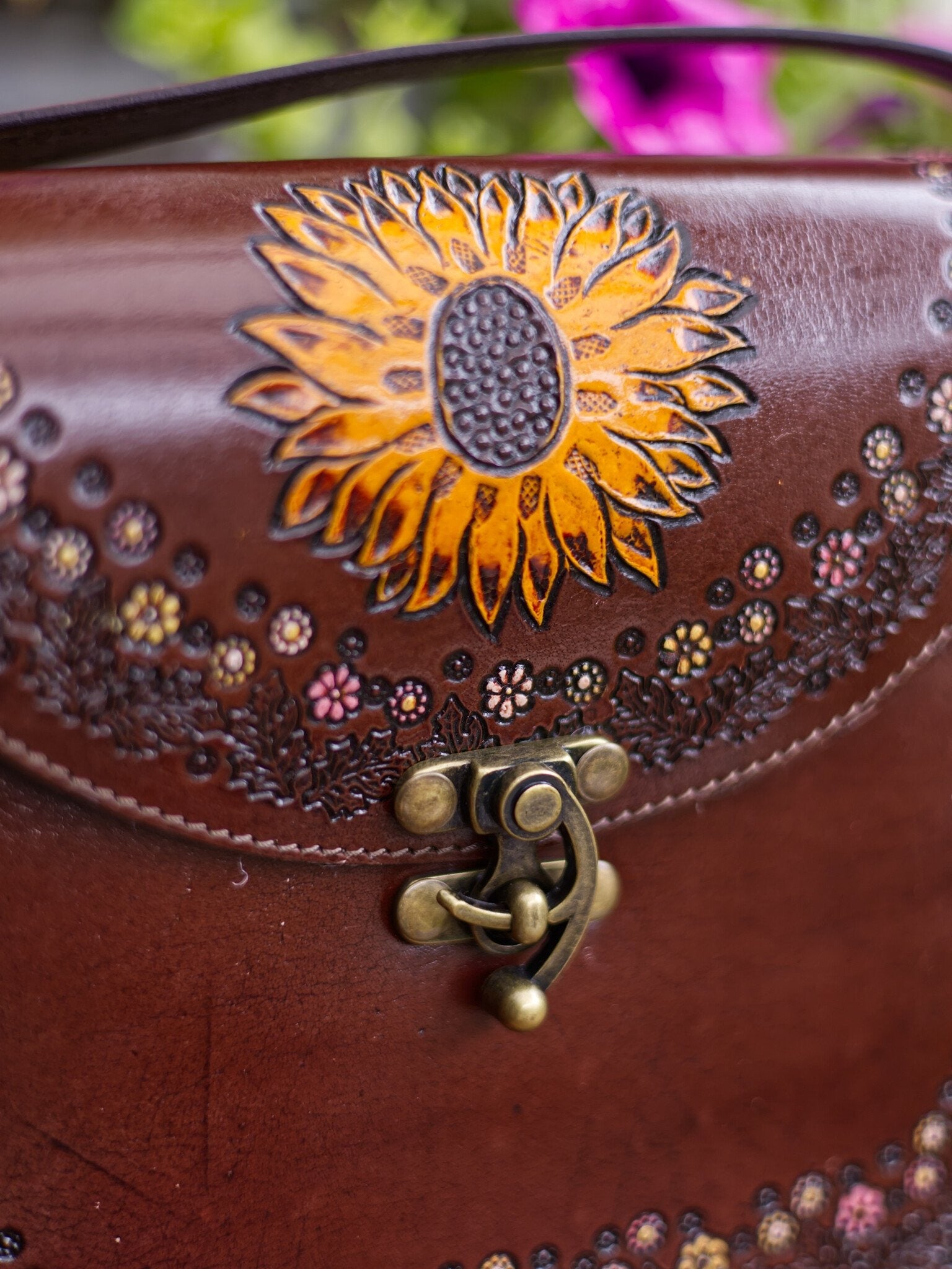 Brown leather bag with sunflower design and decorative elements