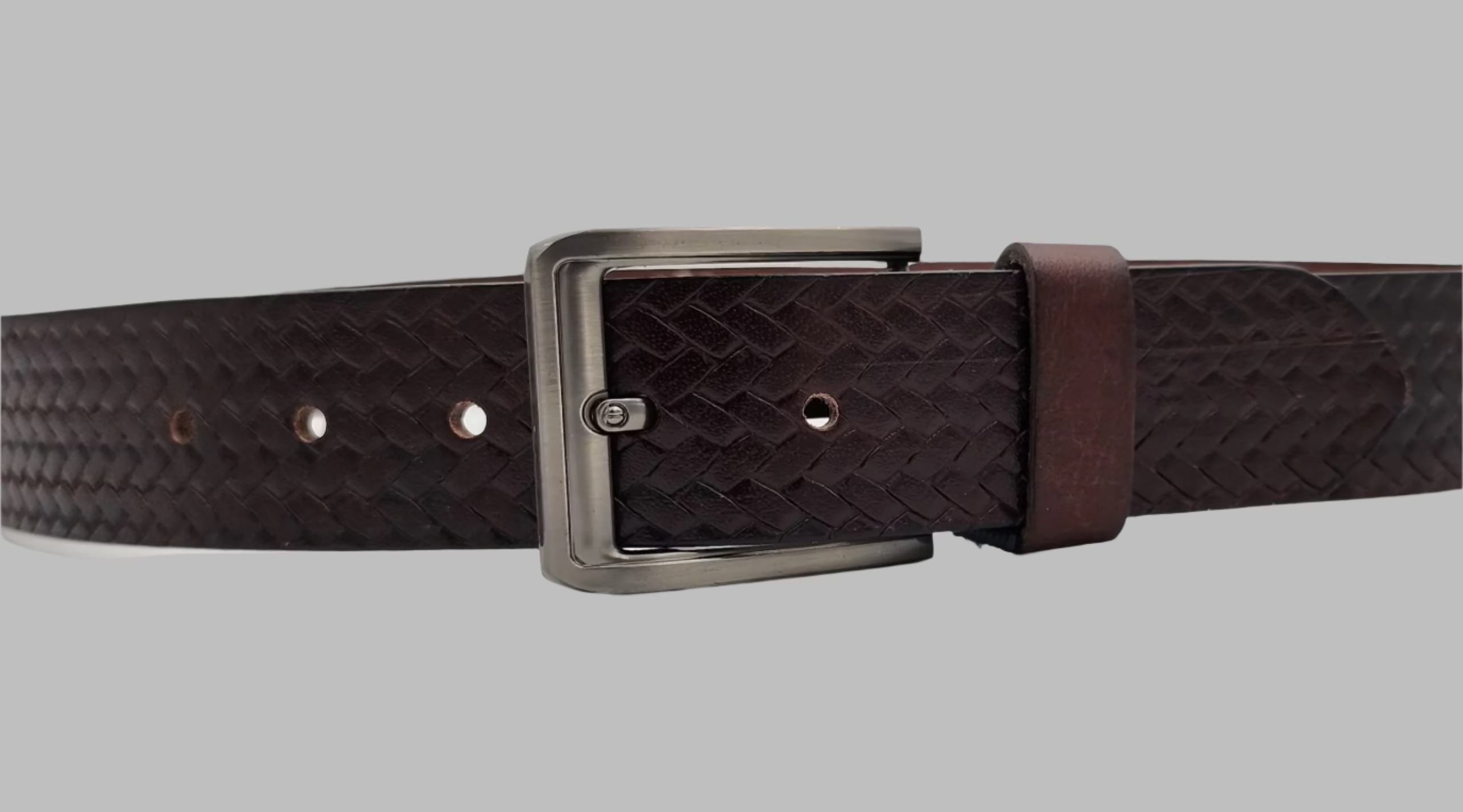 A black and brown full-grain leather belt with a metallic buckle and a checked pattern