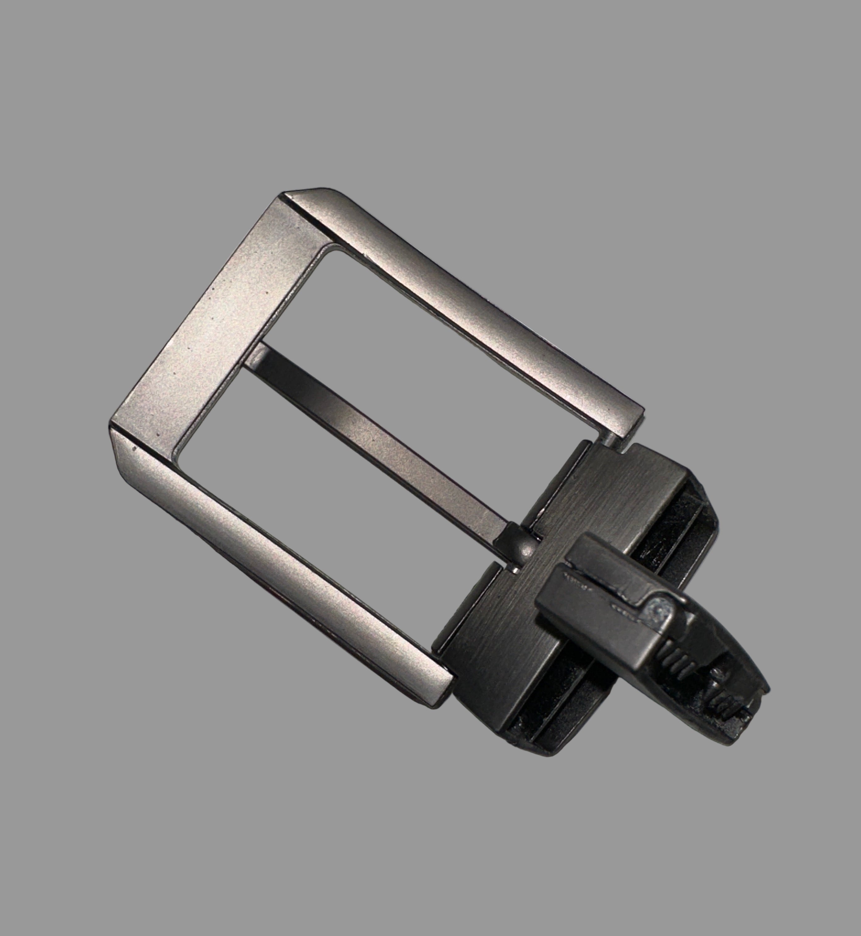 Metallic watch buckle on a gray background