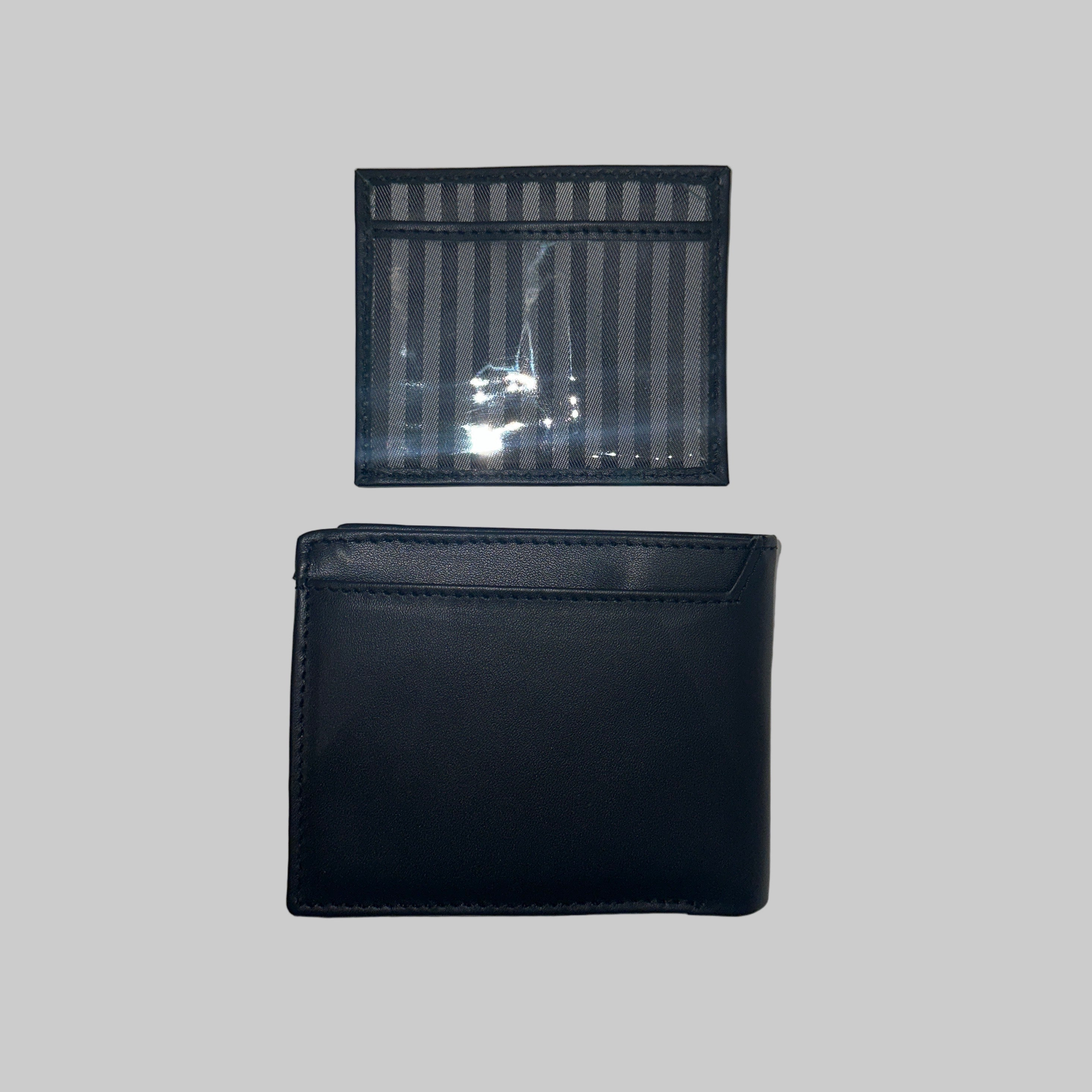 Two wallets, one black and one transparent with striped pattern, on a light gray background.