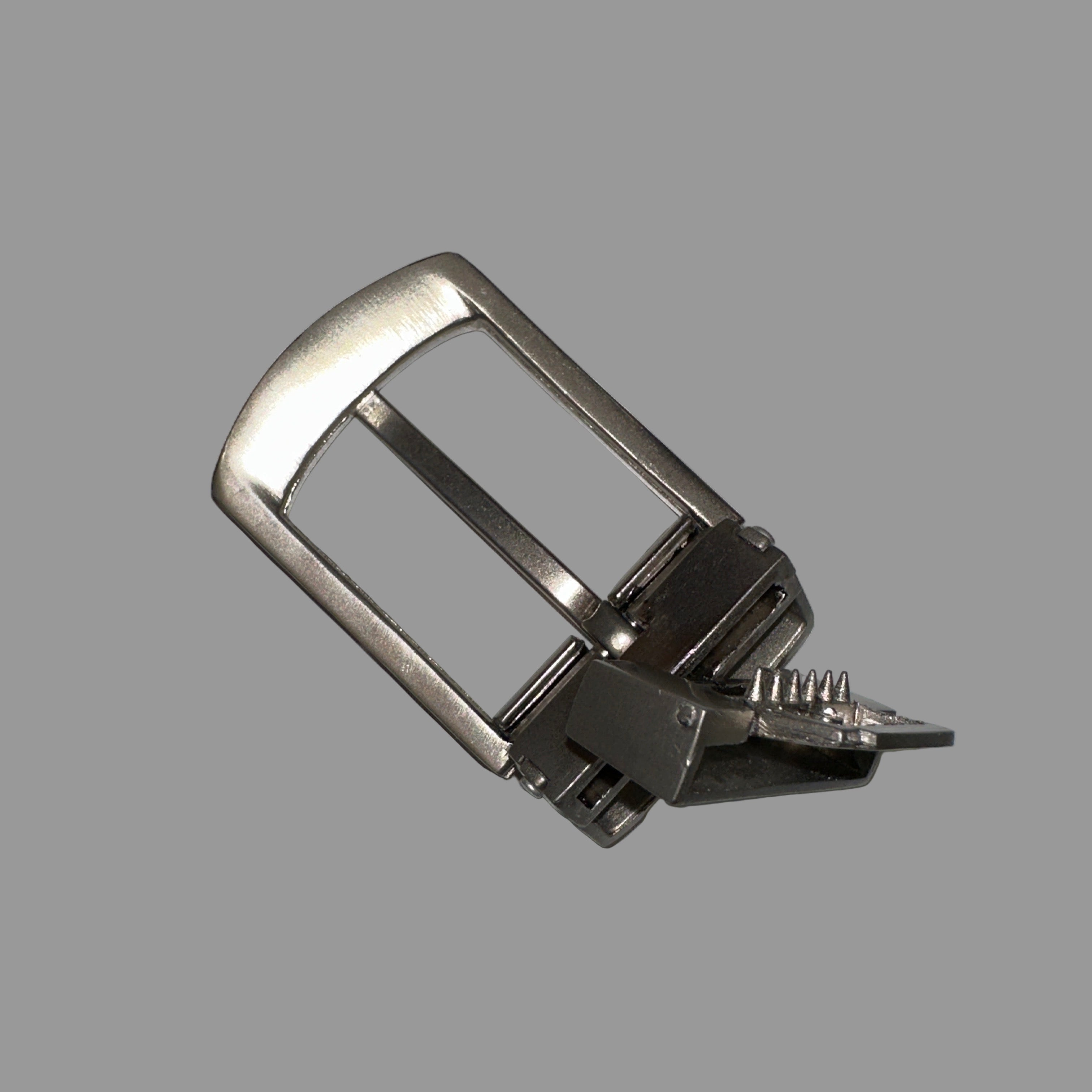 Metal belt buckle on a gray background