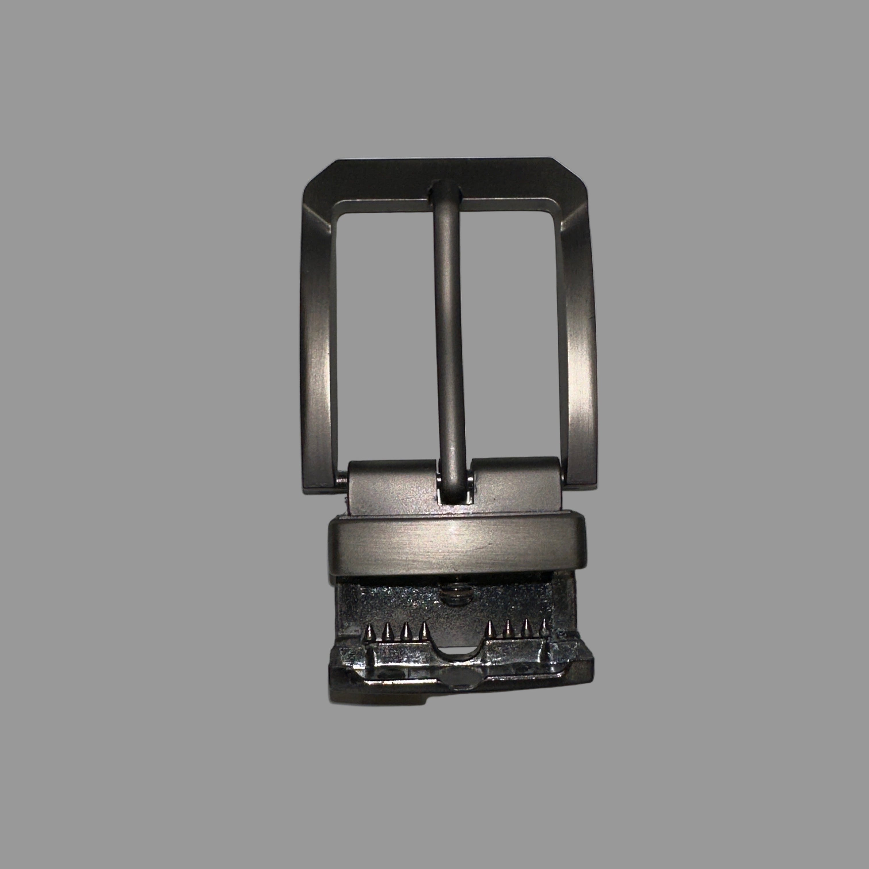 Metallic belt buckle on a light gray background