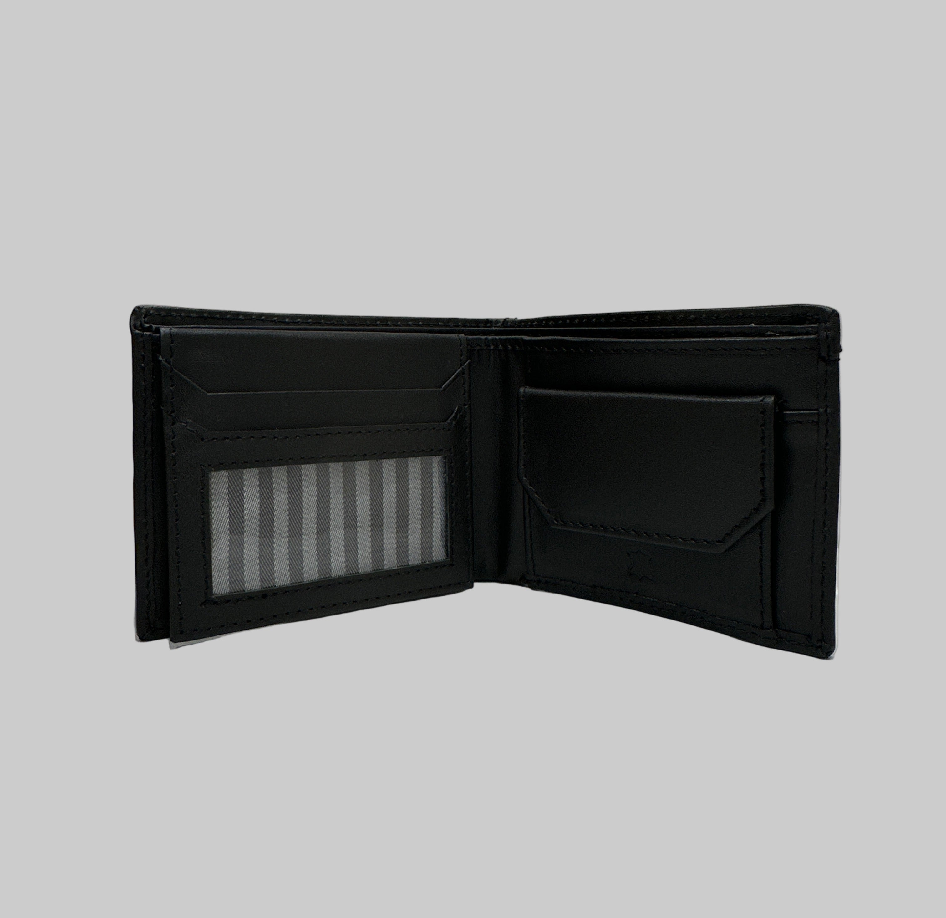 Black wallet on a white surface with a wooden object underneath