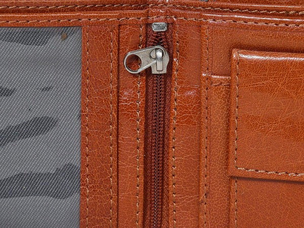 Close-up of a brown leather wallet with a zipper pocket.