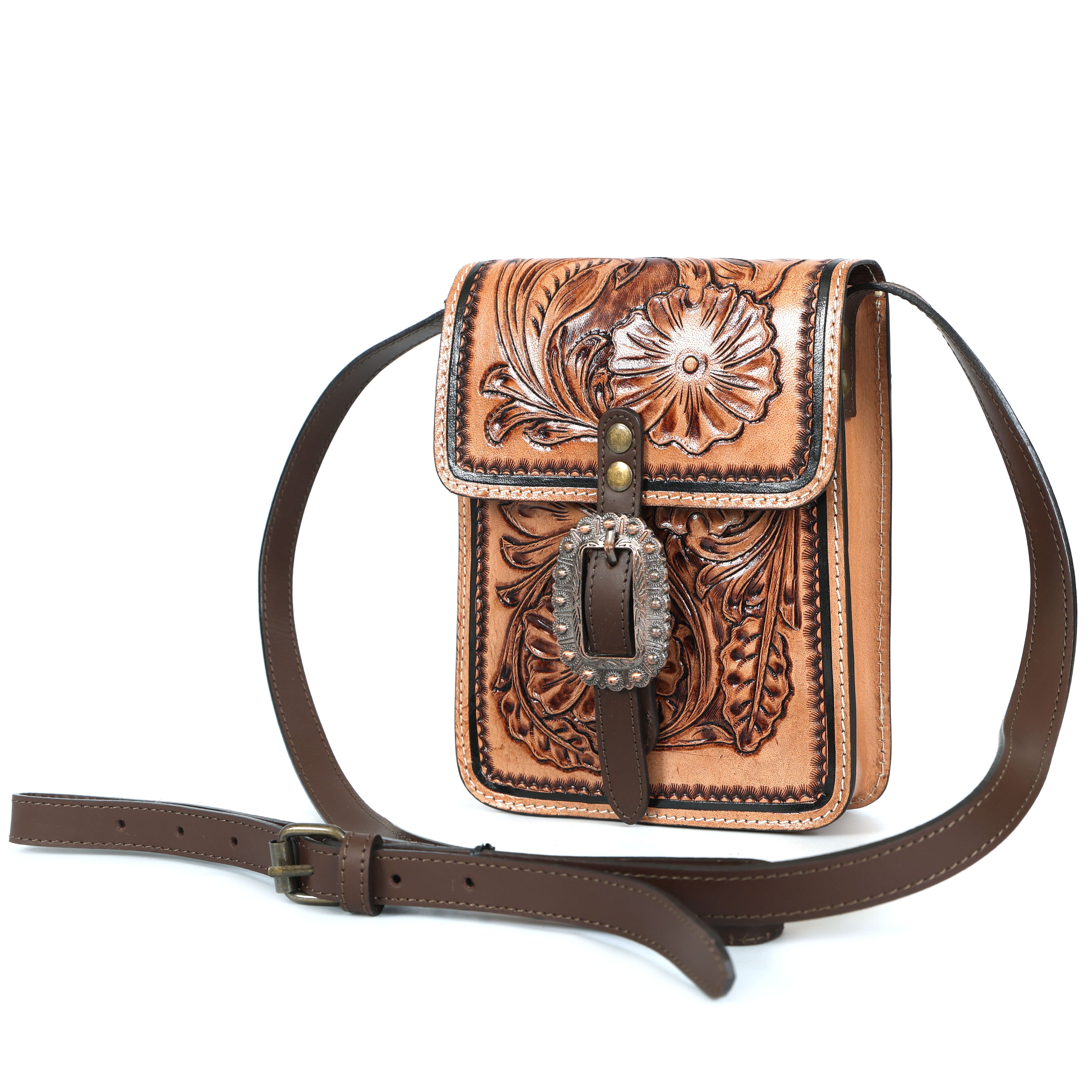 Luxury artisan floral tooled leather crossbody bag in saddle tan with antique silver buckle, handcrafted for women, premium full-grain leather handbag designed in New Zealand and Australia.