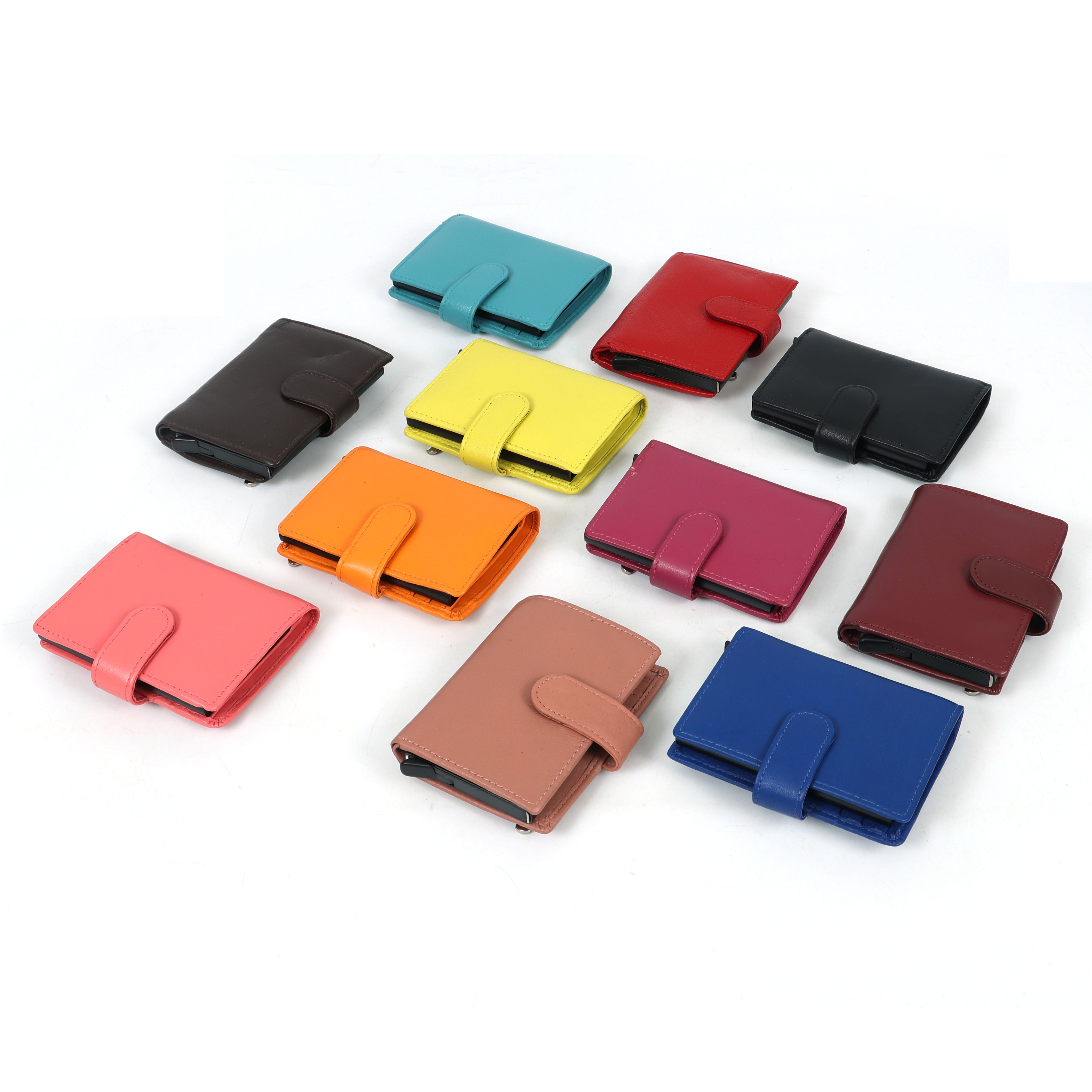 Assorted colorful leather card holder wallets displayed in rows, featuring snap-closure designs in pink, orange, yellow, blue, red, brown, and black.