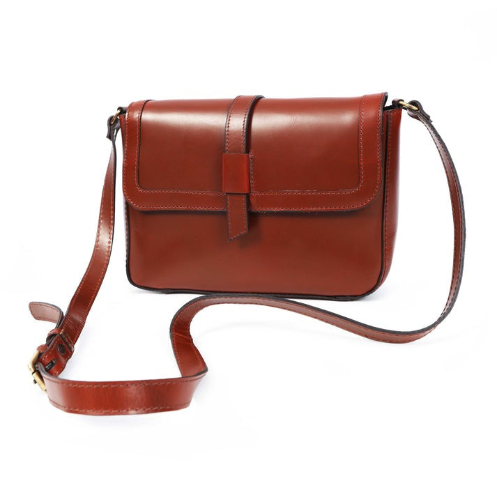 A front-facing view of a women's rich brown full-grain leather crossbody satchel bag with a buckle-style flap closure and adjustable strap, sold by GM Leather Auckland