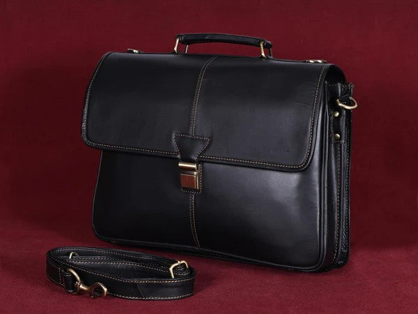 classic black full-grain leather men's briefcase with brass-tone latch and shoulder strap, available at GM Leather Auckland.