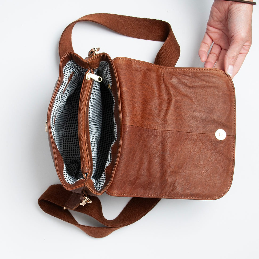 Open black leather crossbody bag showing interior compartments by GM Leather Auckland