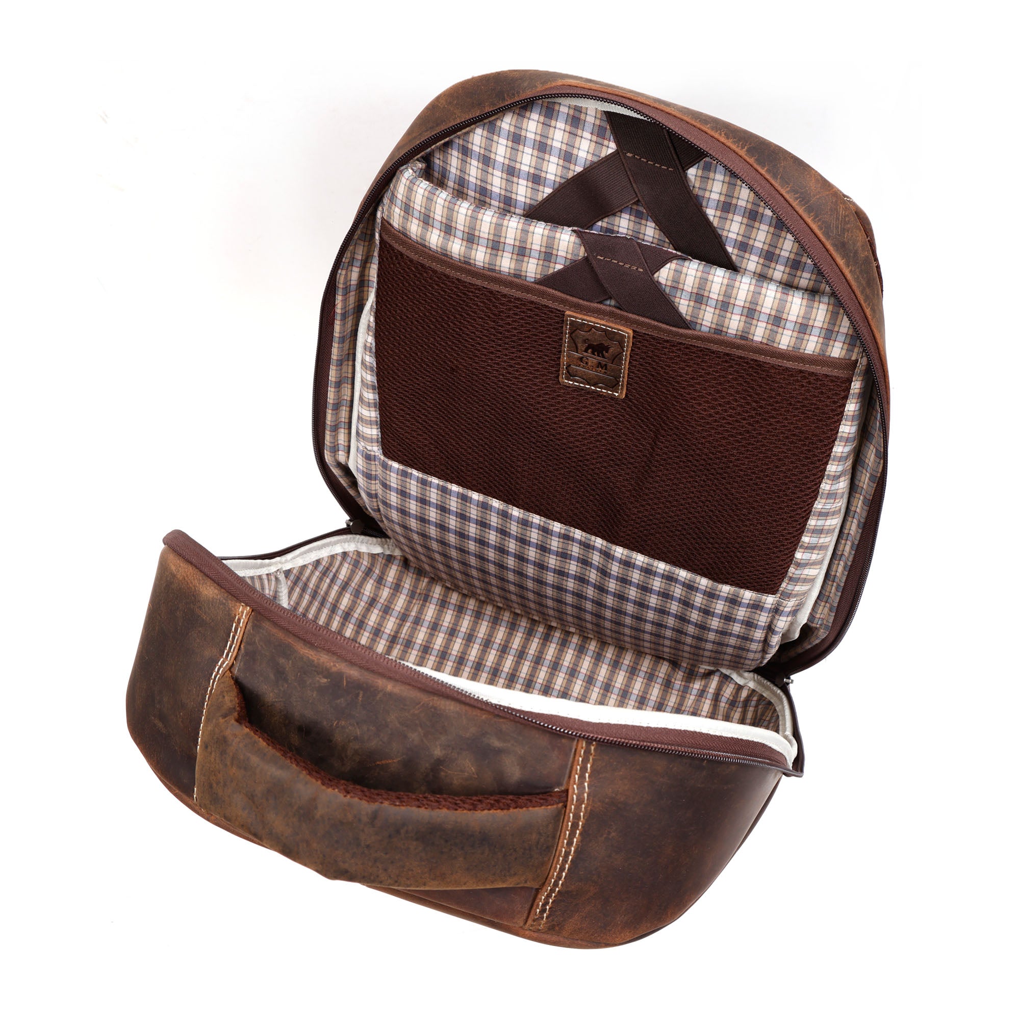 GM Leather backpack interior organization and authentic leather brand patch.