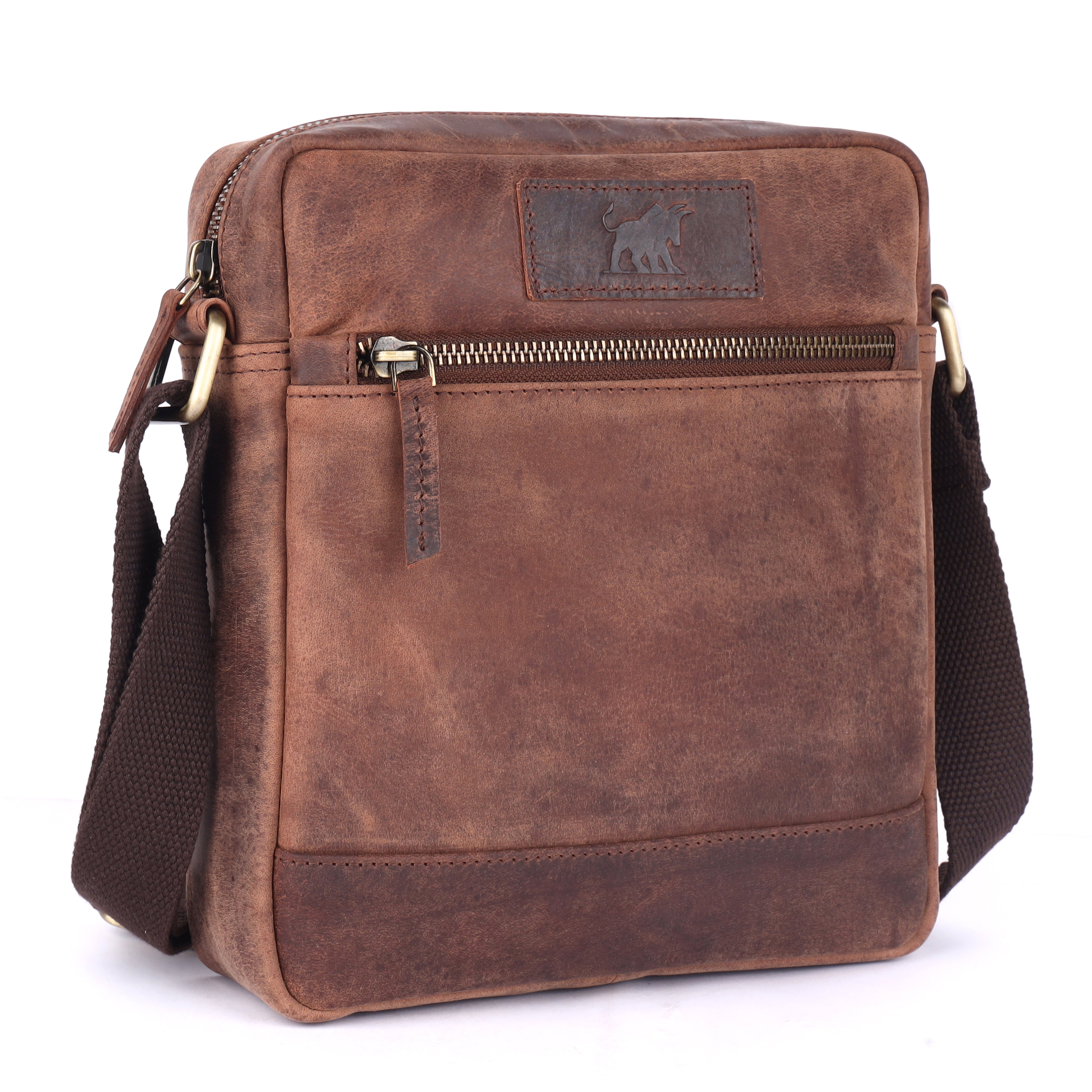 Side profile view of the GM Leather brown full-grain shoulder pack highlighting its robust thickness, solid brass d-rings, and heavy-duty adjustable canvas strap.