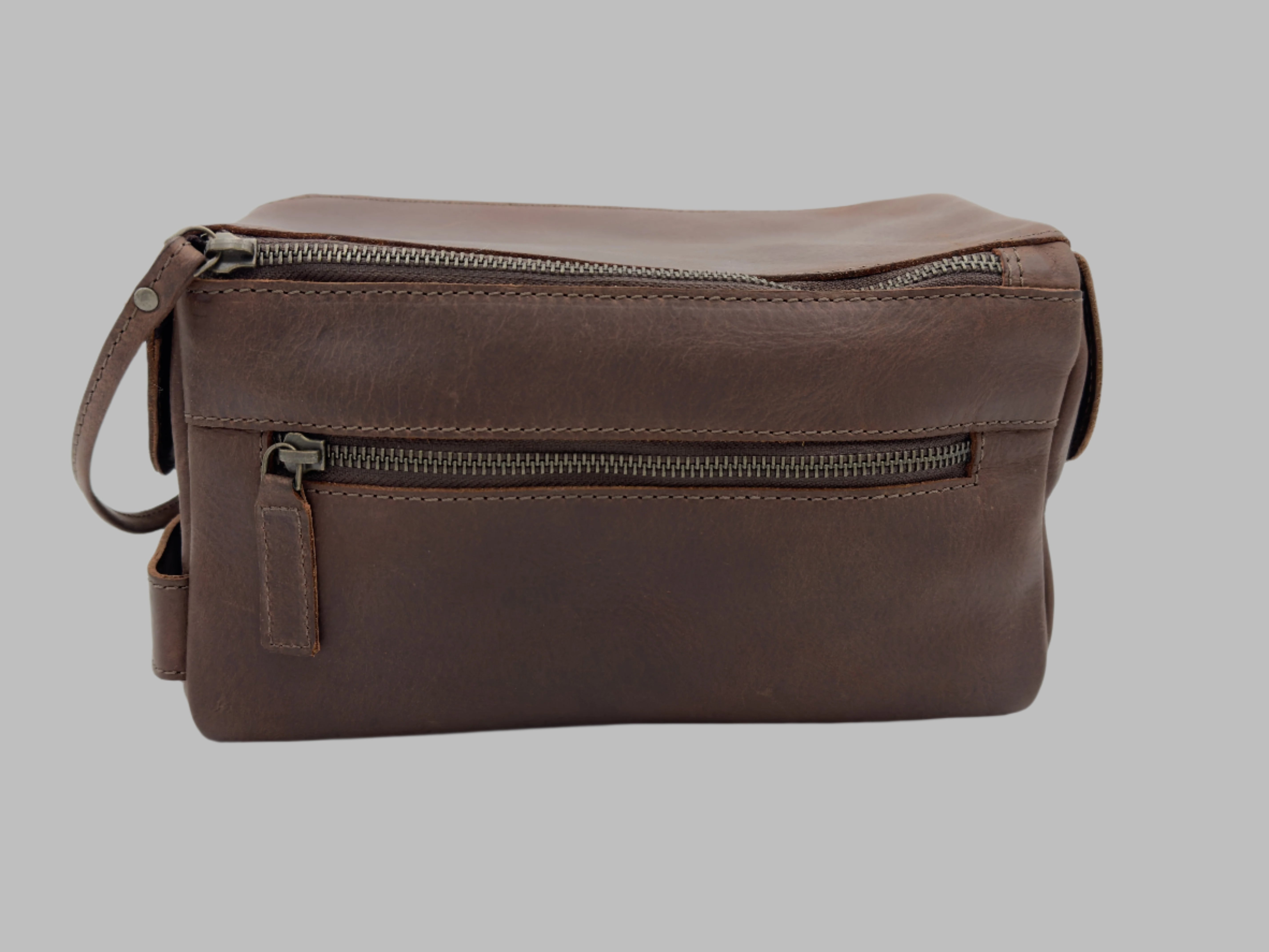 Brown leather toiletry bag with front zip pocket handcrafted by GM Leather Auckland, featuring premium full-grain leather and durable metal zippers