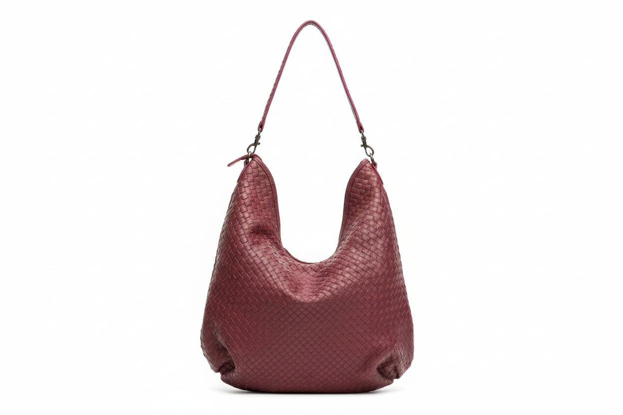 A luxury GM Leather handcrafted burgundy wine-colored woven leather shoulder bag showing the intricate artisan weave, available at LynnMall Auckland.