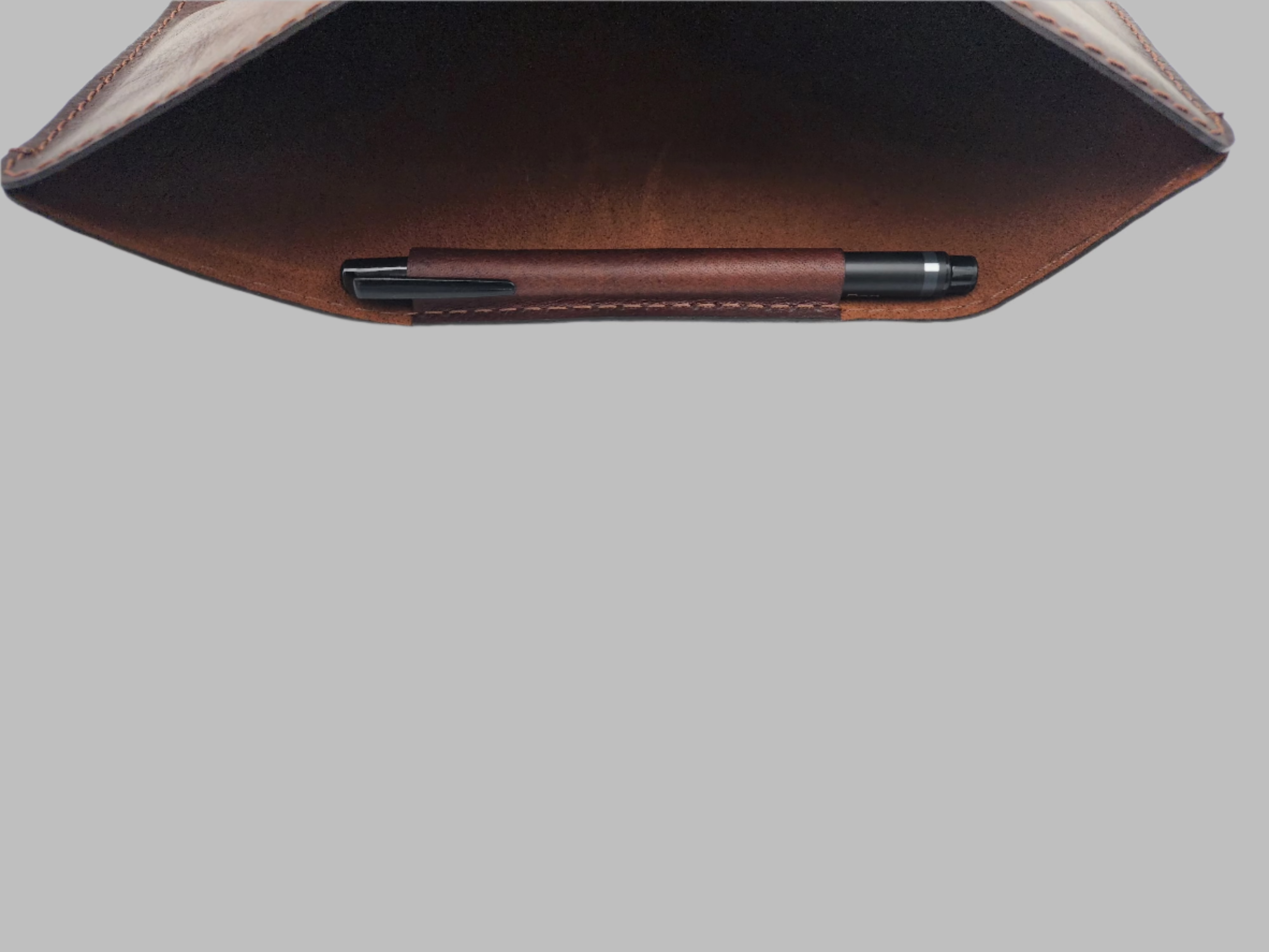 Interior view of a GM Leather handcrafted iPad sleeve showing the integrated pen holder and soft protective lining, available at LynnMall Auckland.