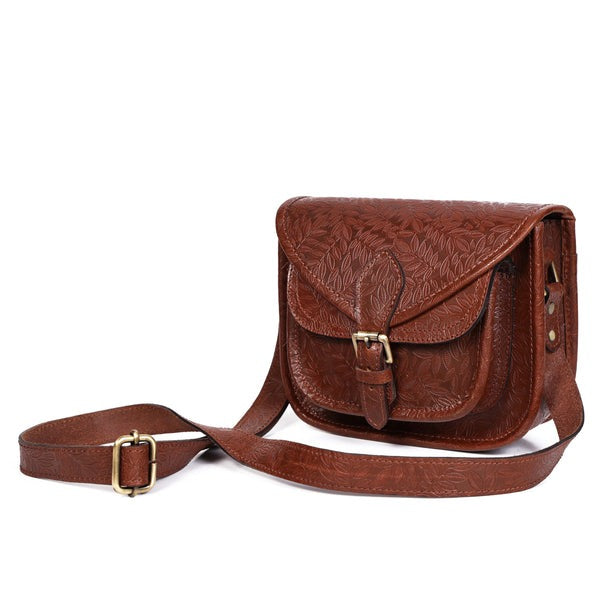 GM Leather Auckland handcrafted brown leather crossbody bag featuring intricate leaf embossing and brass buckle closure.