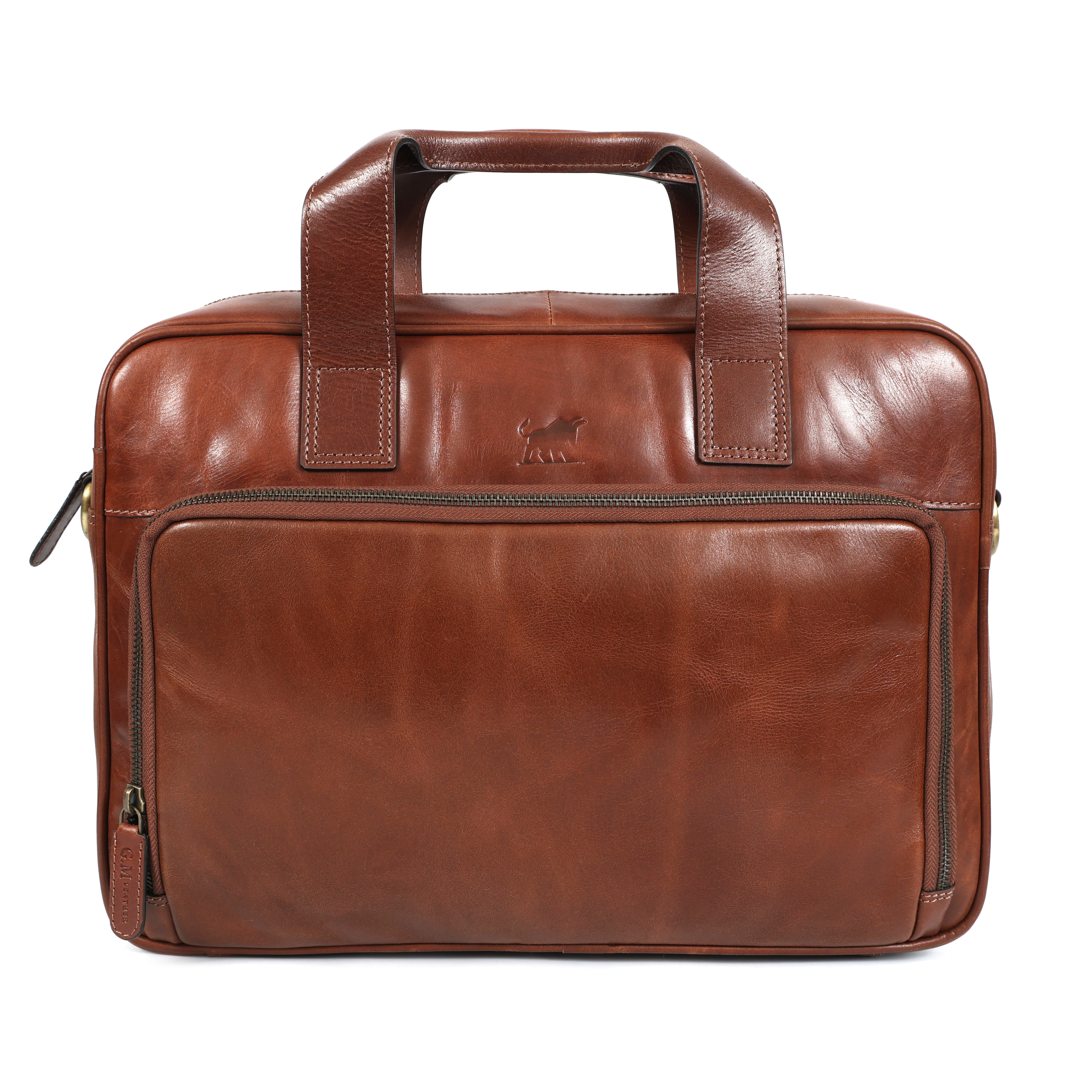 A premium, tan brown full-grain leather men's briefcase with a detachable shoulder strap, dual zipper compartments, and the embossed GM Leather Auckland logo, photographed on a white background.