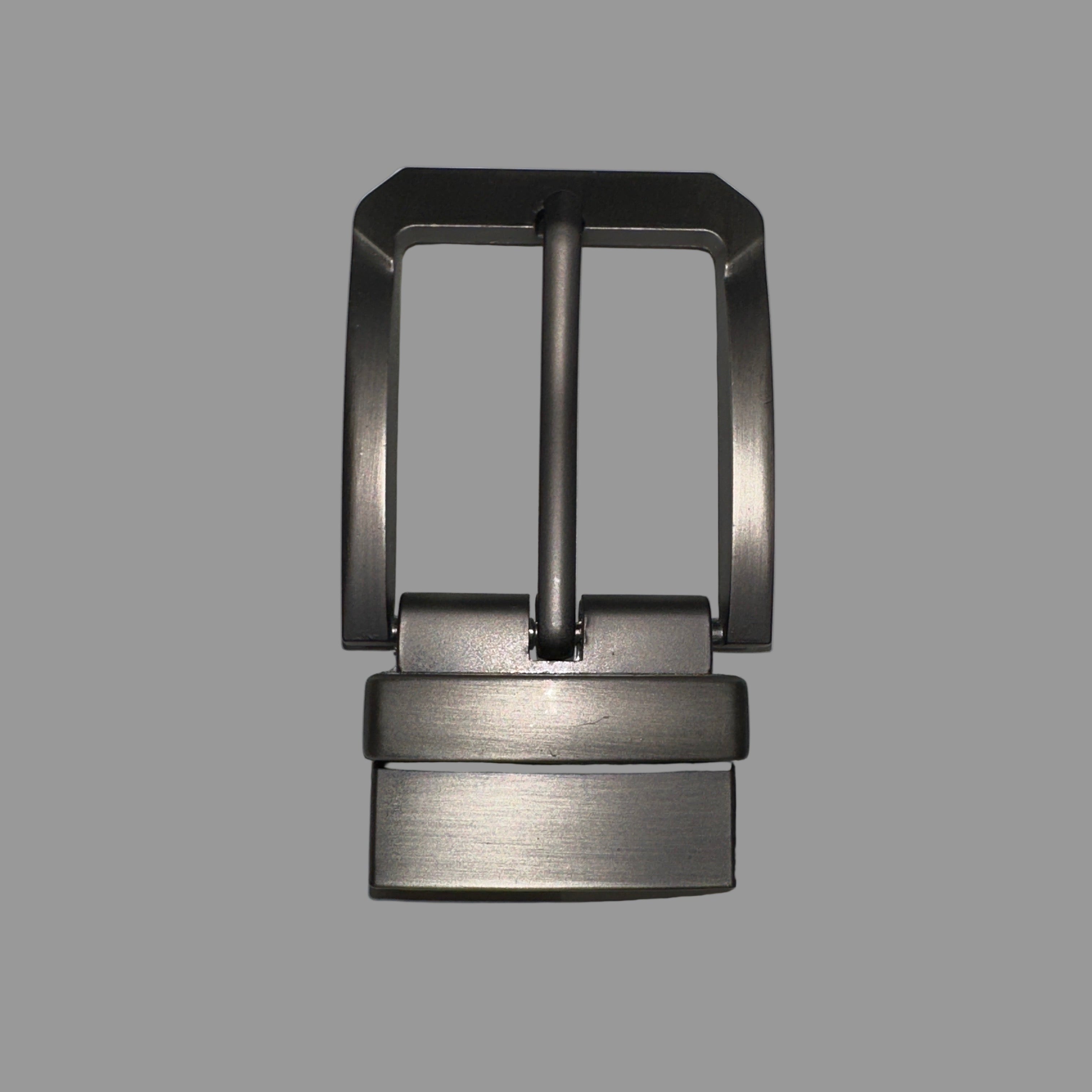 A close-up of a premium, brushed gunmetal grey reversible belt buckle with a swivel frame and single prong, showing its heavy-duty construction from GM Leather Auckland