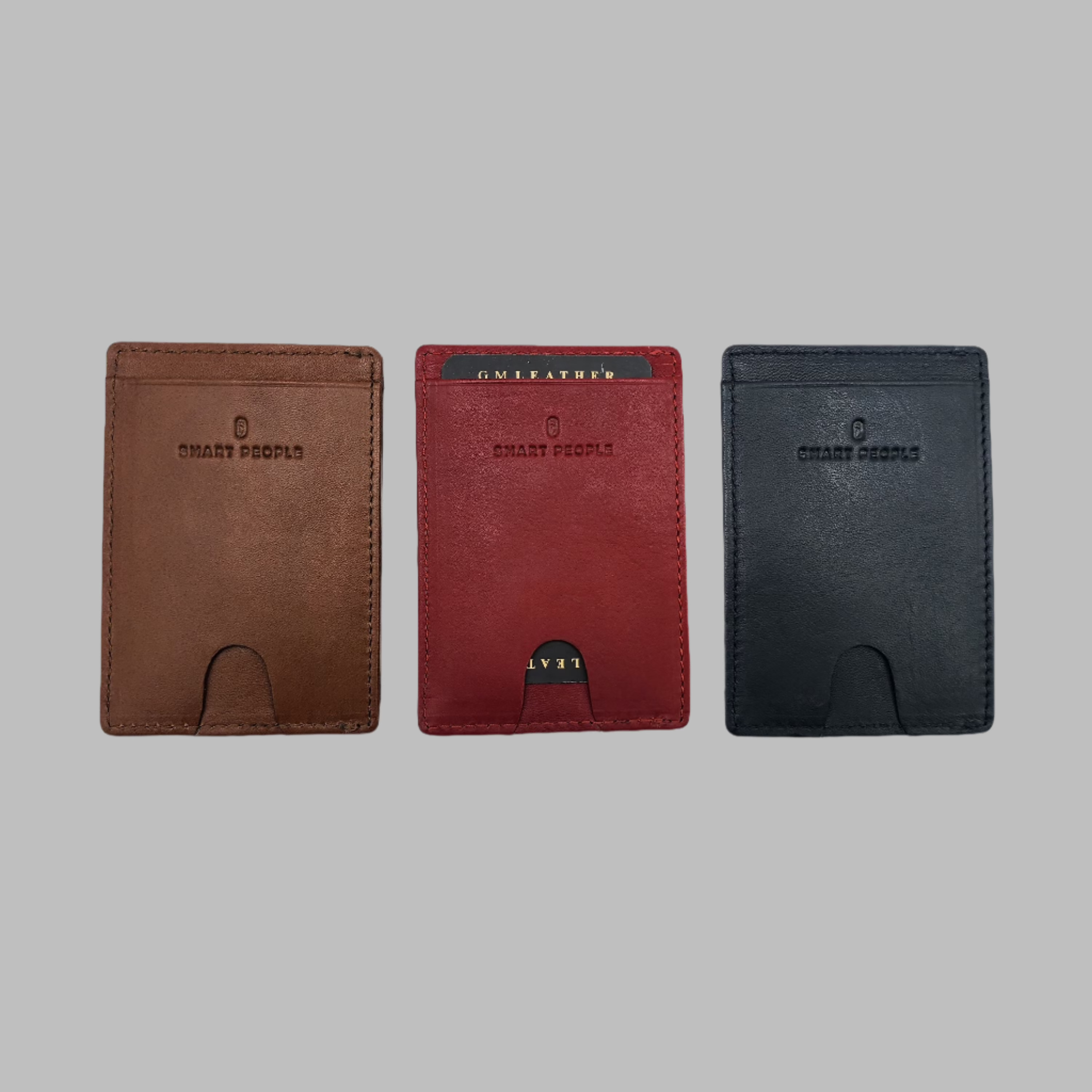 Three leather card holders in brown, red, and black colors, displayed vertically on a plain background.