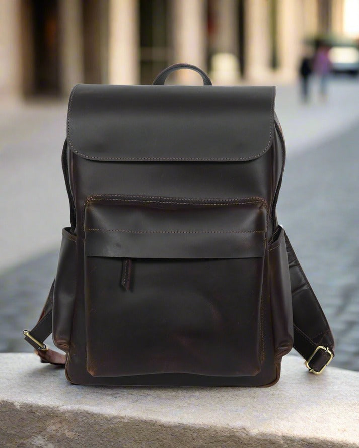GM Leather Auckland men's dark brown full-grain leather flap backpack, ideal laptop bag for work or travel, available for purchase at Lynnmall New Lynn NZ.