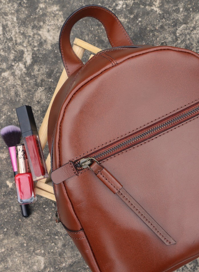 GM Leather Auckland brown full-grain leather mini backpack for women, stylish small leather bag with zipper details, perfect for everyday use or local purchase at Lynnmall New Lynn NZ.