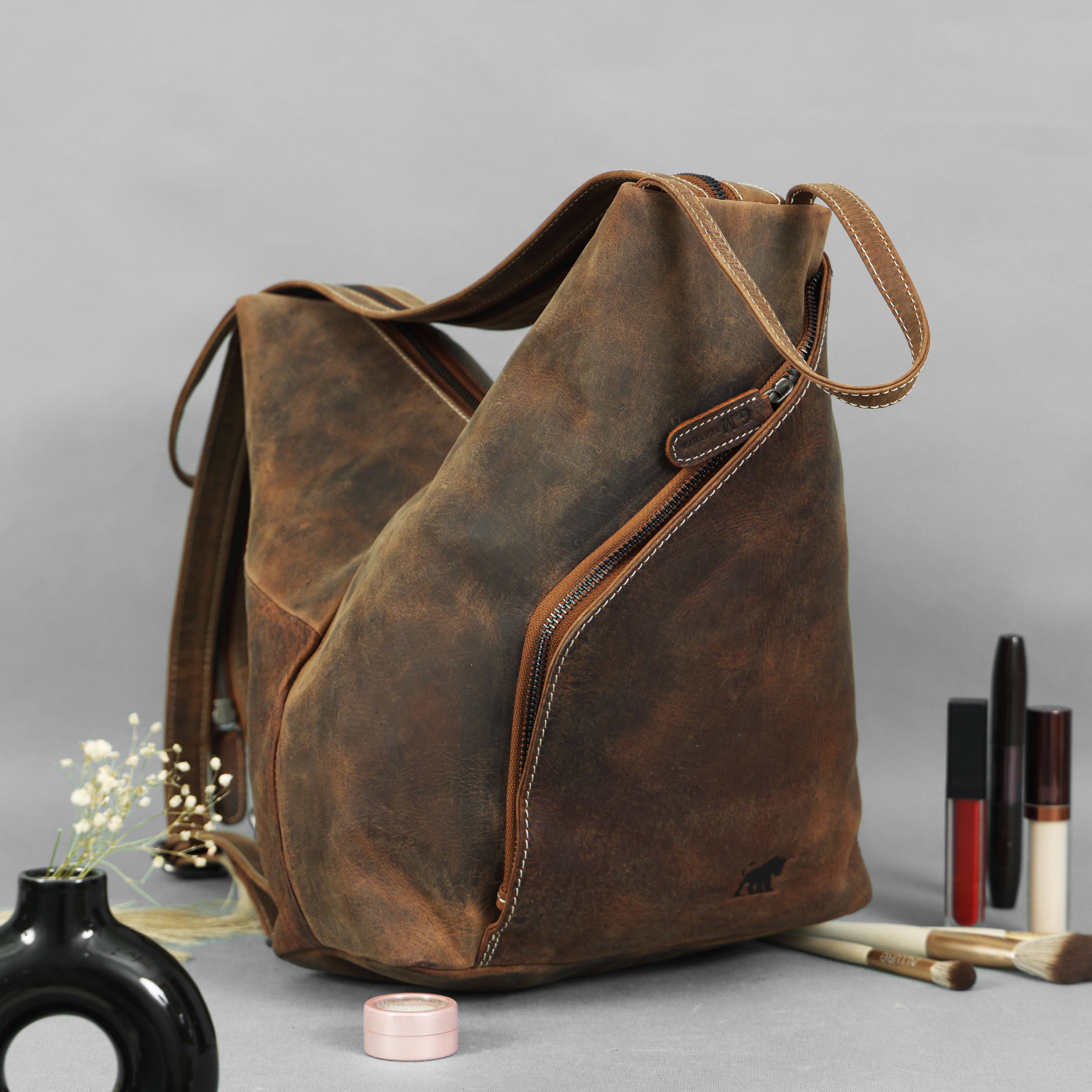 Brown vintage hunter leather convertible backpack and tote bag with white stitching and zipper details